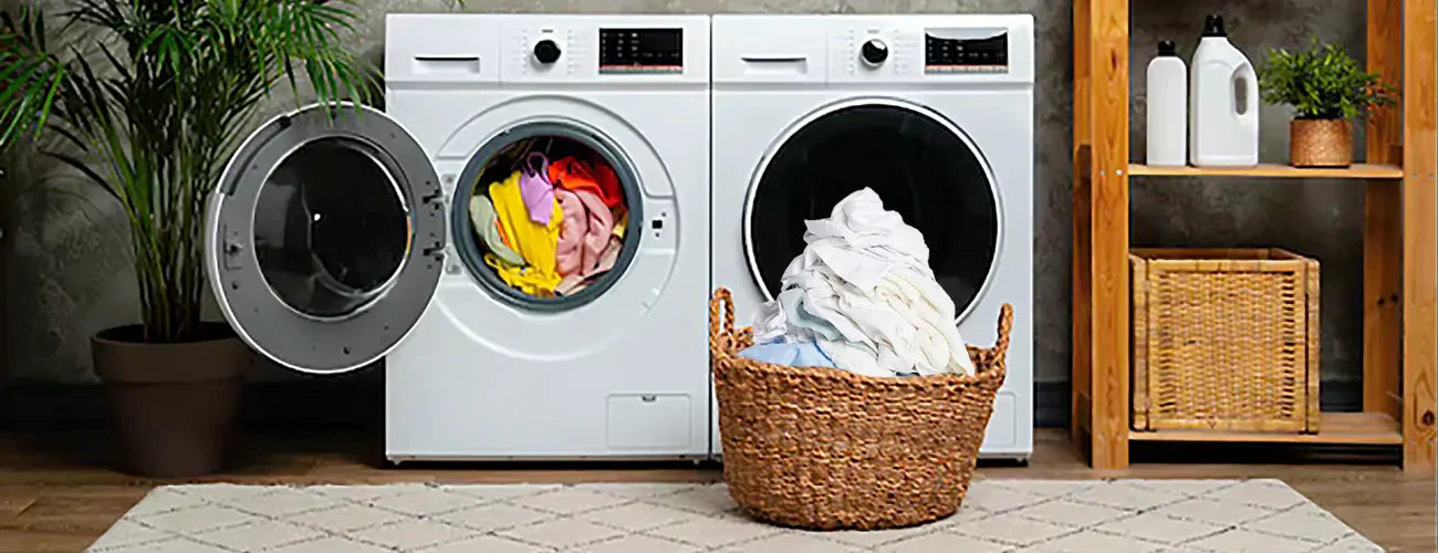 Laundry with separated laundry one pile of coloured clothes in the washing machine and a pile white clothes in a basket