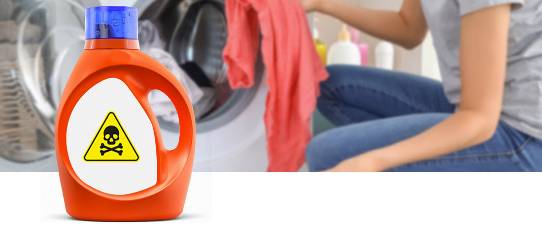 Woman putting laundry made up of clothes into a front loader washing machine. Large plastic bottle of laundry liquid detergent in the foreground of image